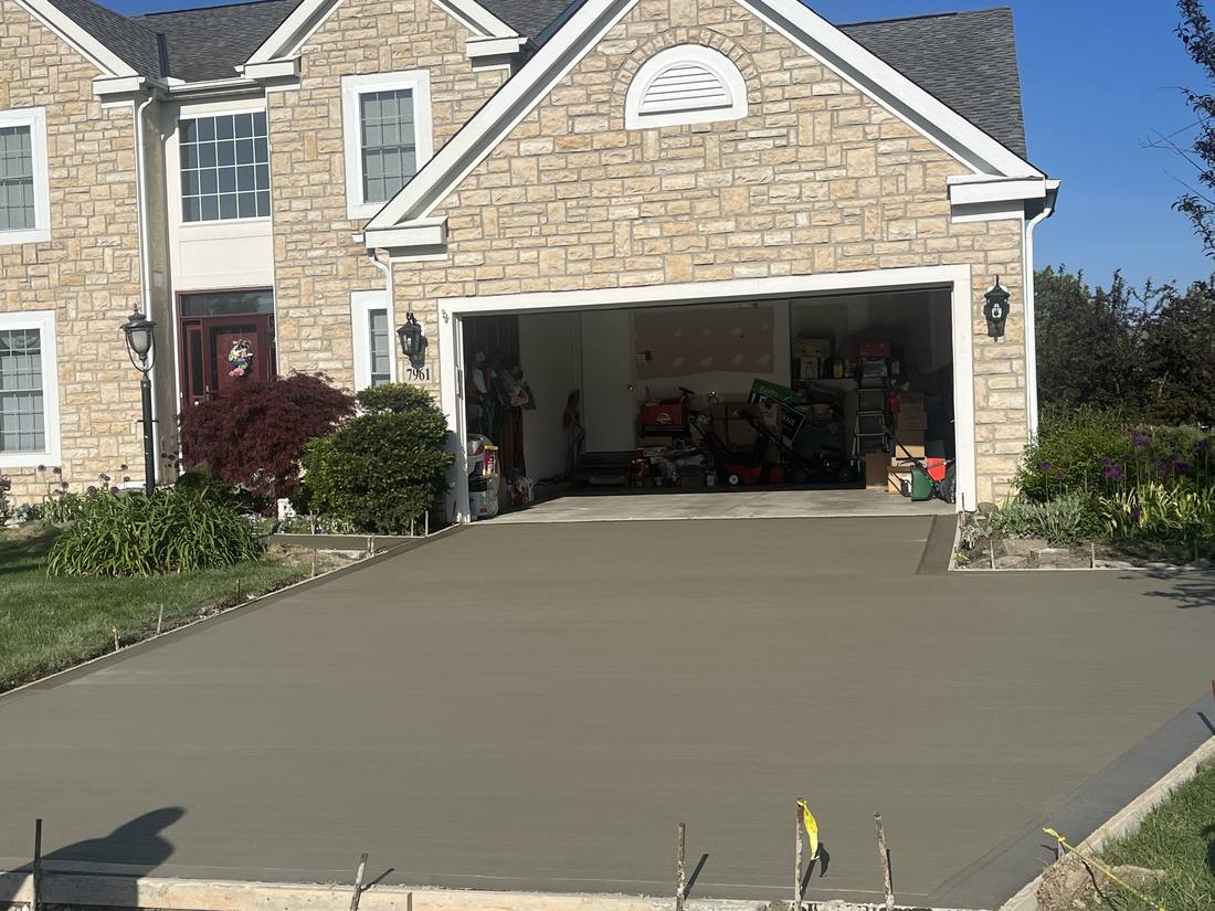 Driveway, stone-front home