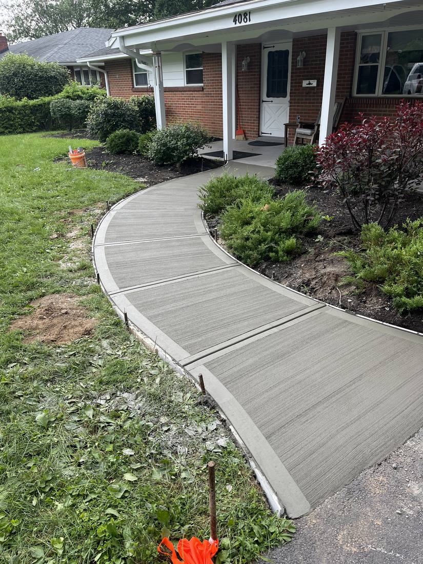 Curved walk to a brick ranch
