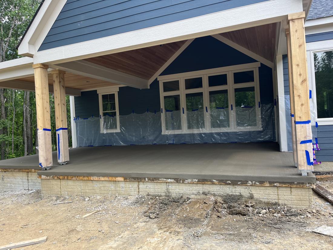 Covered porch at a navy farmhouse