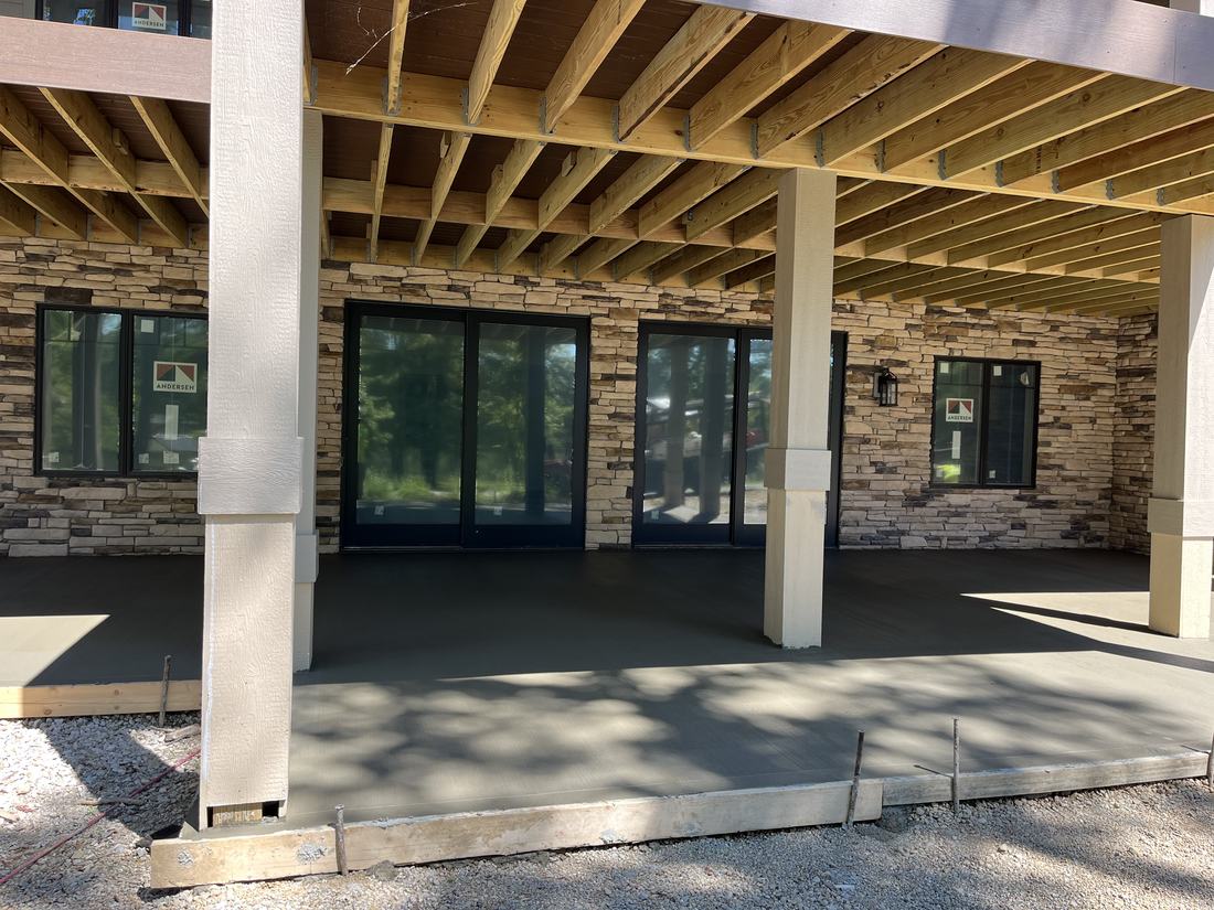 Patio under the deck, stone home
