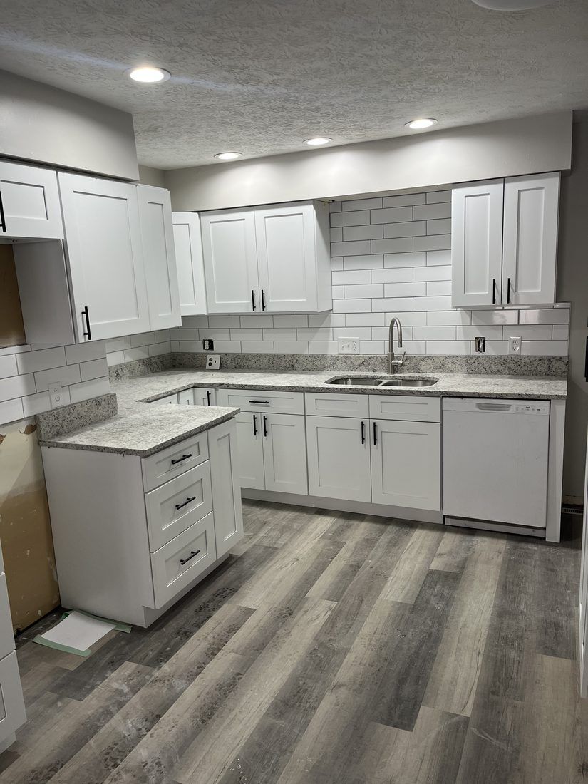 White shaker kitchen with luxury vinyl plank
