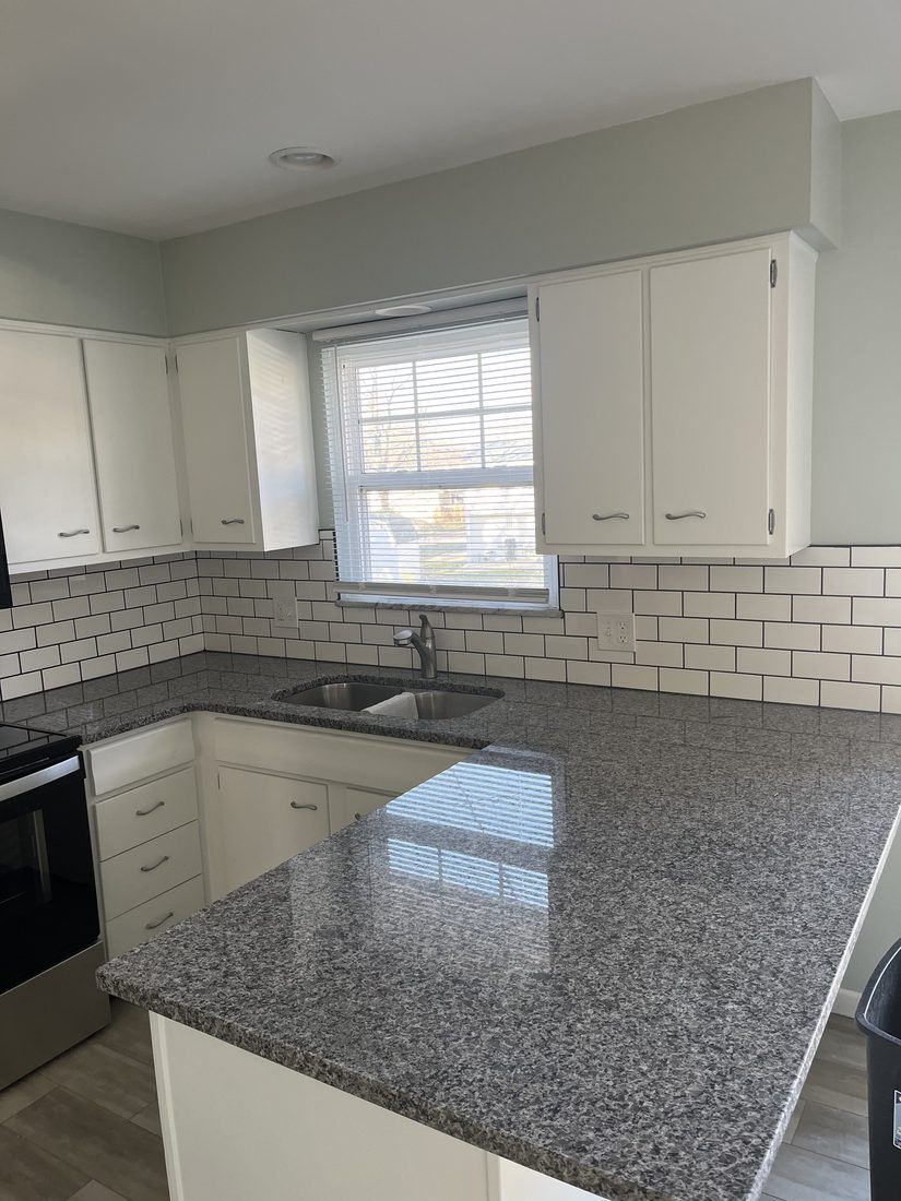 Granite counters and subway tile backsplash