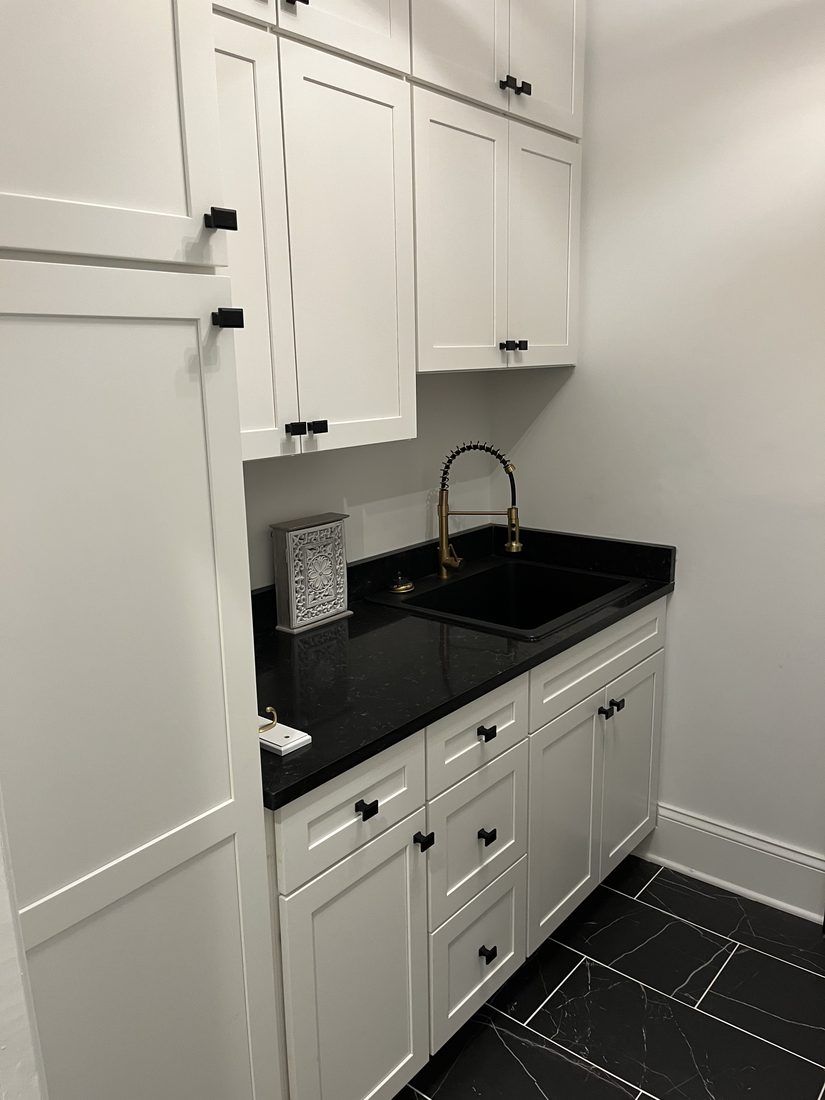 Butler's pantry with black granite and brass