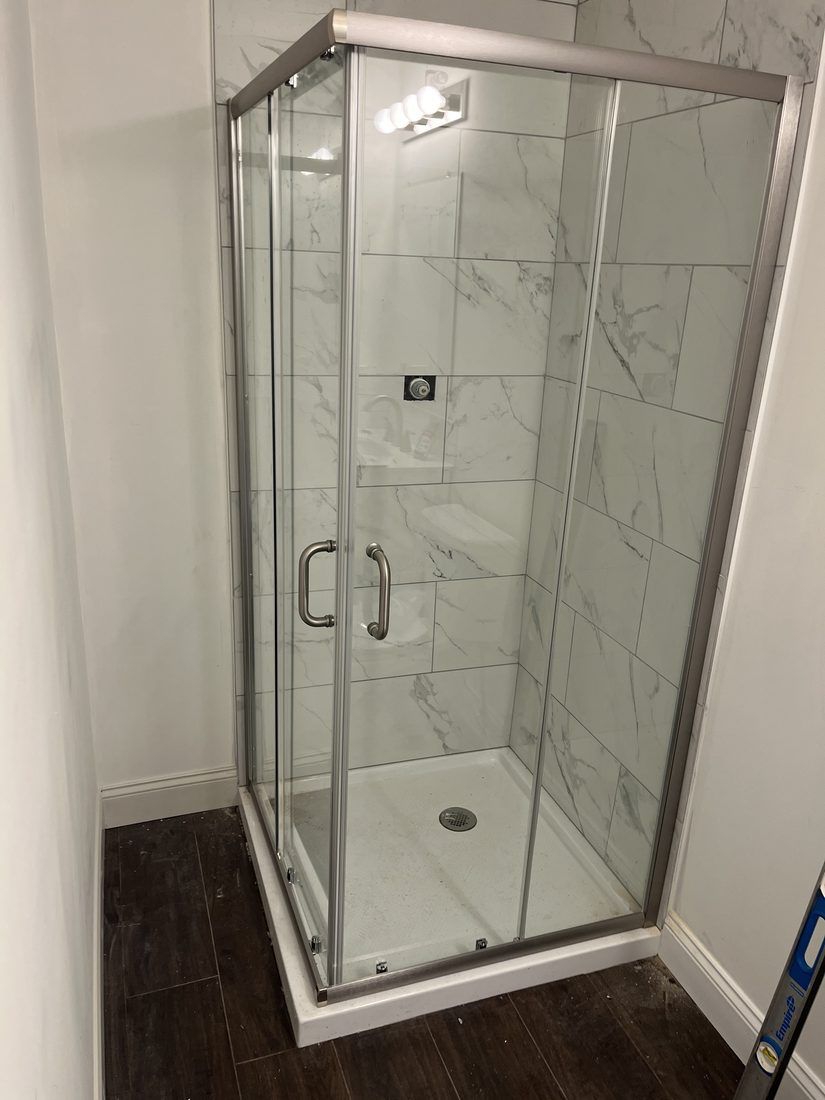 Tiled shower with sliding glass door