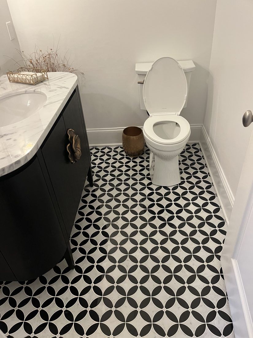 Powder room with patterned marble floor