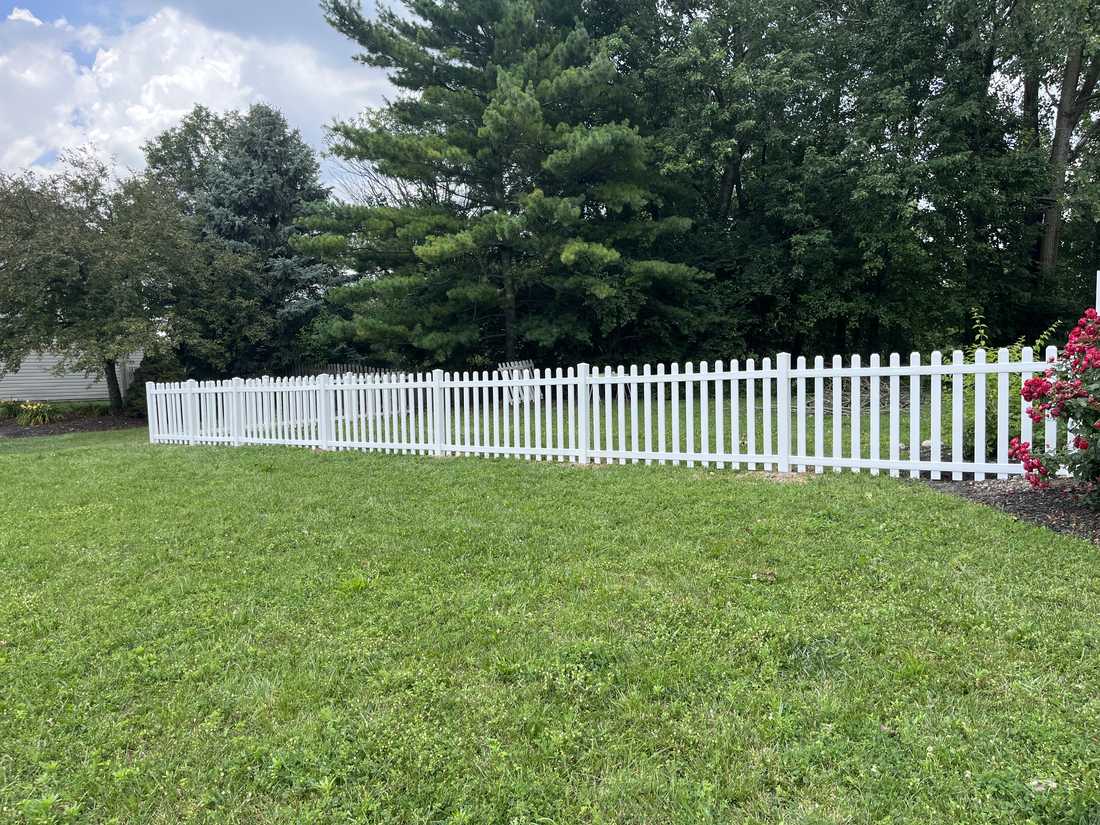 Vinyl picket fence along the yard